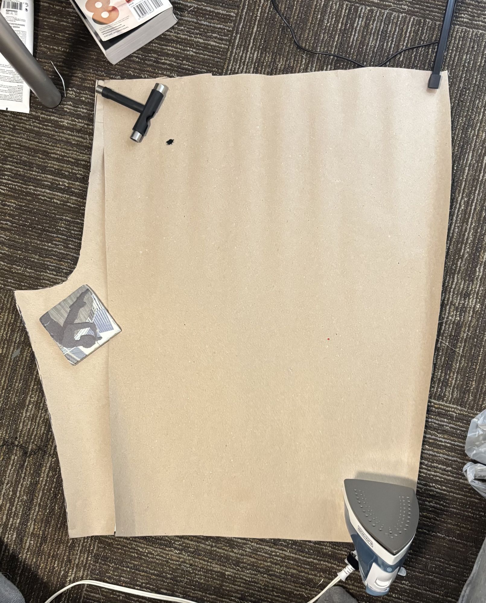Flannel pattern piece laid out with tracing-wheel markings, iron nearby