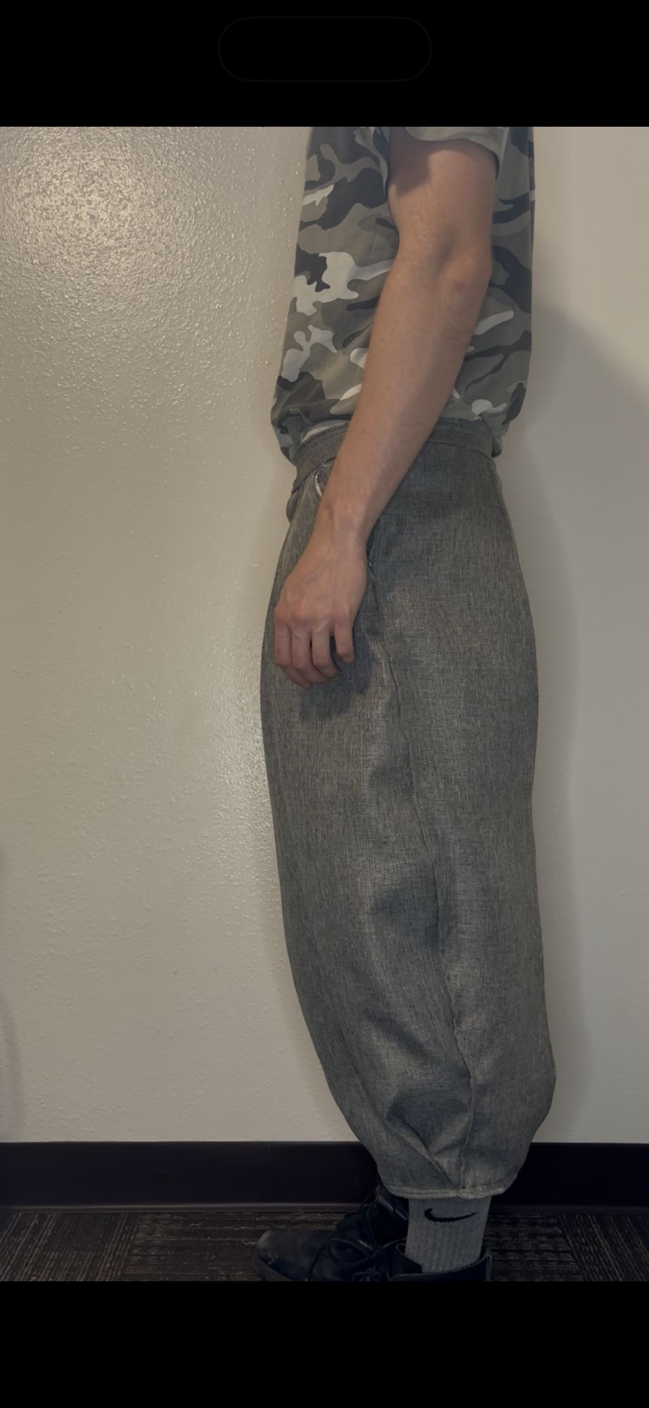 Balloon pleat trouser, side profile showing full leg volume