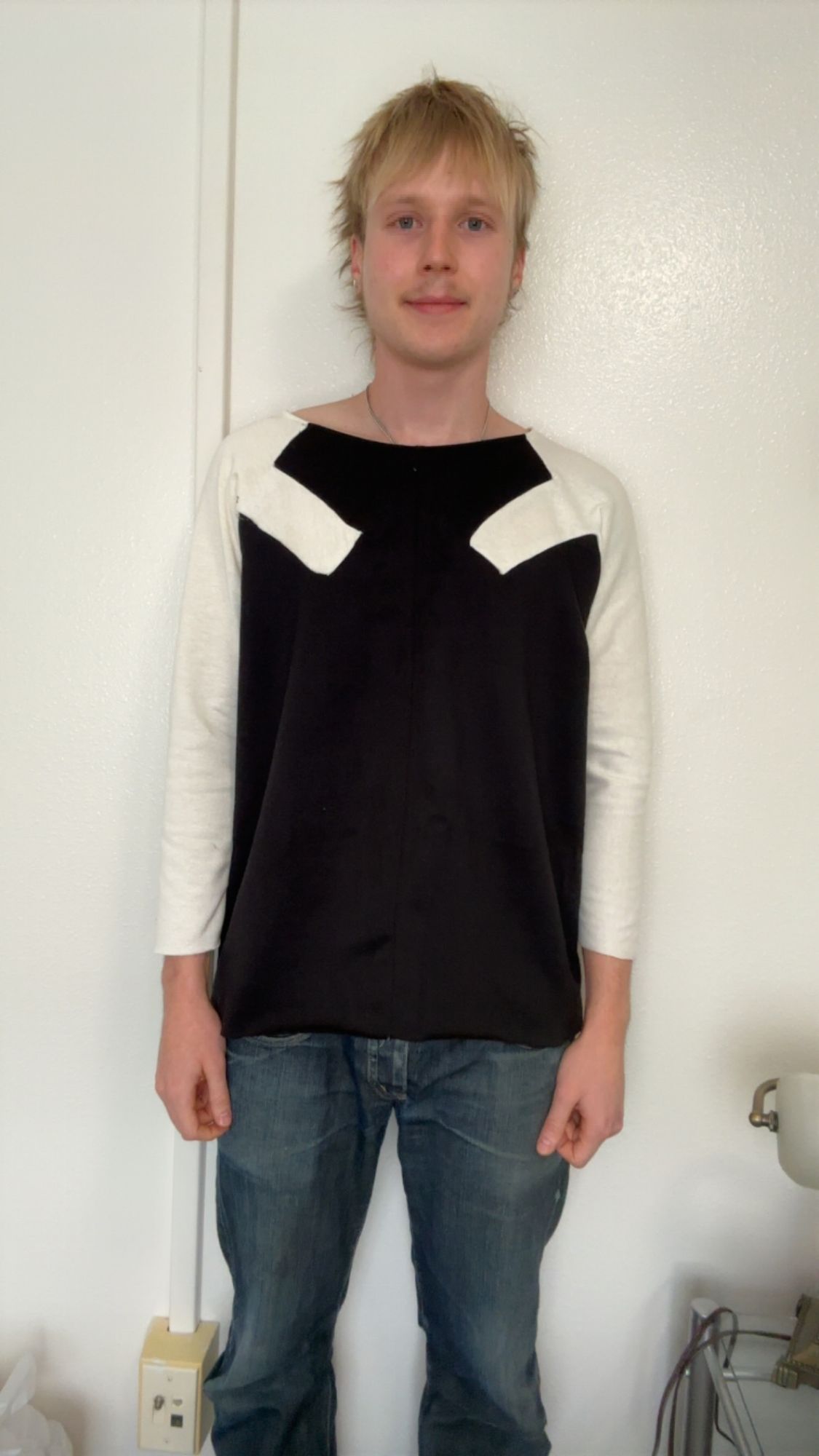 Raglan top, front view, arms outstretched, showing the raglan sleeve seams